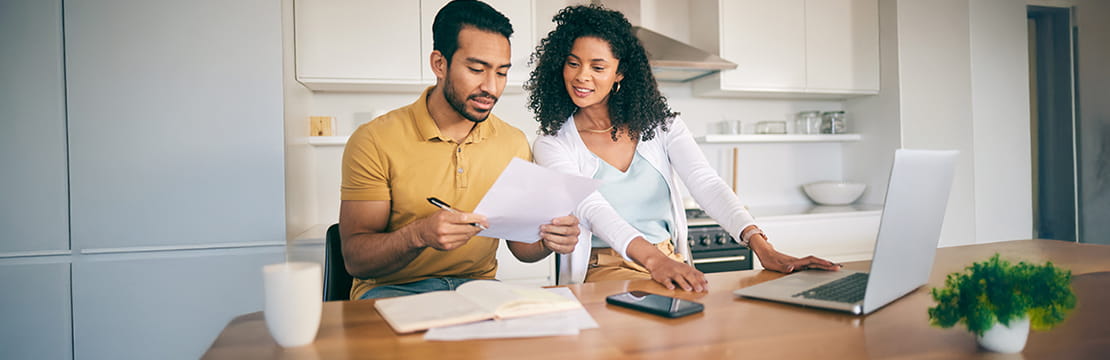 A couple looking at documents in the kitchen